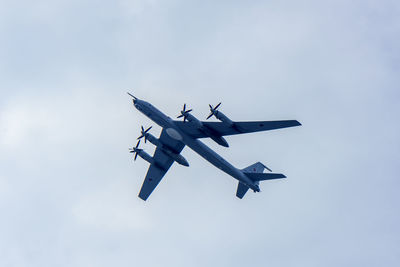 Low angle view of airplane flying against sky