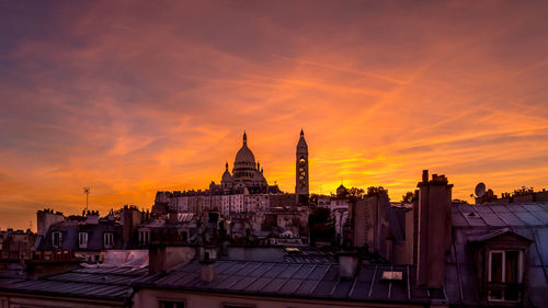 Buildings and basilique du sacre coeur against sky at sunset