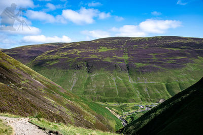 Scenic view of landscape against cloudy sky