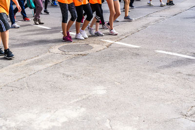 Low section of people walking on road