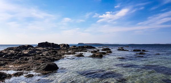 Rocks on beach against sky