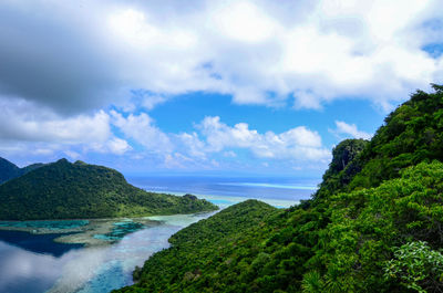 Scenic view of sea and mountains against sky