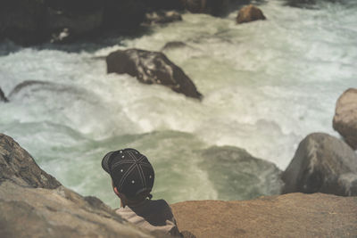 Close-up of a boy sitting at a wild creek in the sequoia national park 