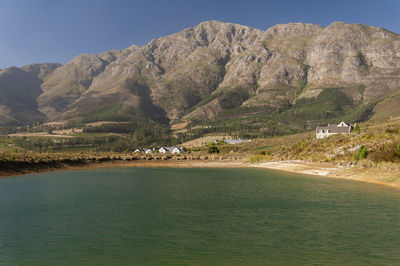 Scenic view of sea and mountains against sky