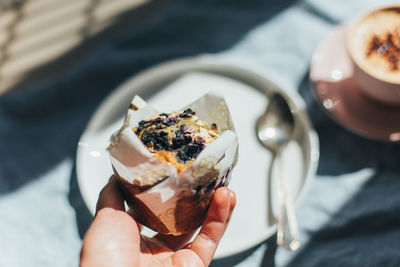 Close-up of hand holding ice cream