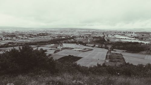 View of cityscape against cloudy sky