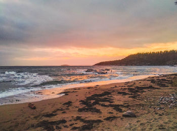 Scenic view of beach against sky during sunset