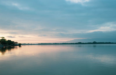 Scenic view of lake against sky at sunset