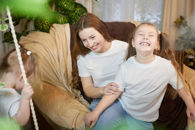 Portrait of friends sitting on field