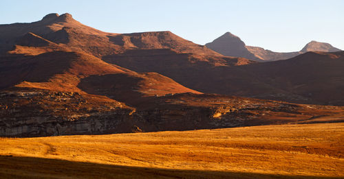 Scenic view of arid landscape against clear sky