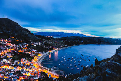 Aerial view of city by sea against sky