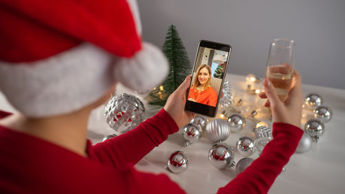 Midsection of woman holding mobile phone