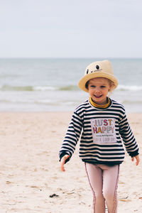Full length of boy standing on beach
