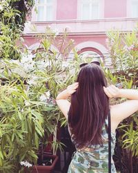 Rear view of woman against plants