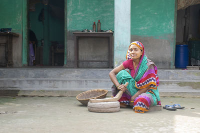 Full length of woman sitting in basket