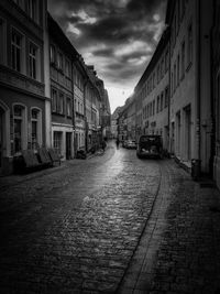 Empty alley amidst buildings in city