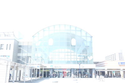 Facade of modern office building against sky