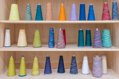 Close-up of colorful threads on shelf