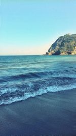 Scenic view of beach against clear sky