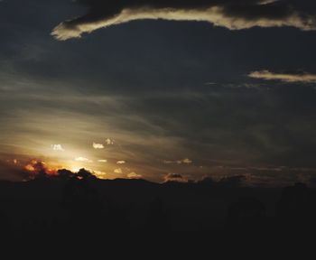 Silhouette landscape against sunset sky