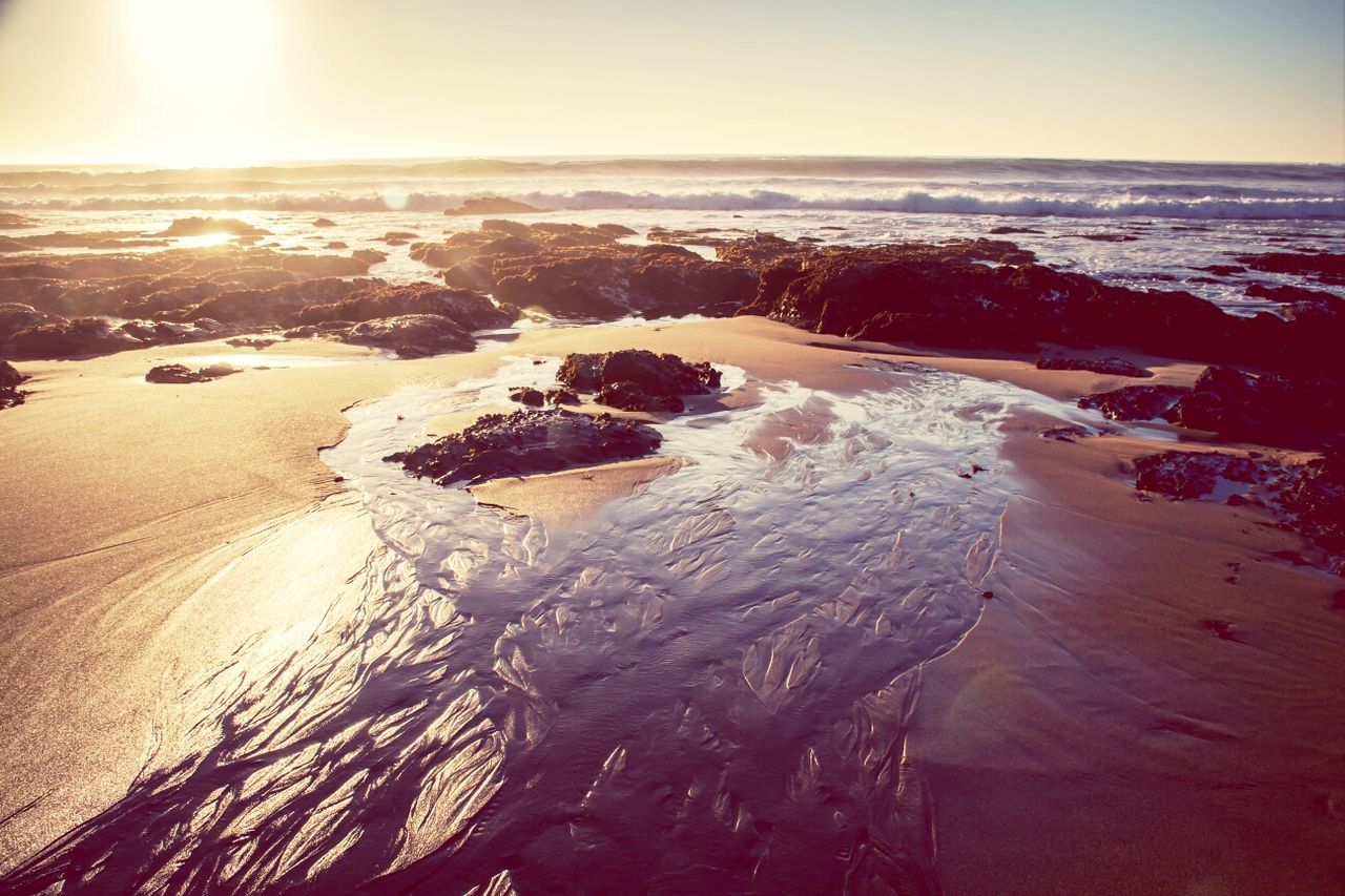 sea, beach, water, horizon over water, shore, sand, scenics, tranquil scene, tranquility, beauty in nature, nature, sunlight, wave, sun, clear sky, sunset, coastline, idyllic, sky, surf