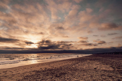 Scenic view of beach against sky during sunset