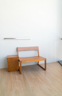 Empty chairs on hardwood floor at home