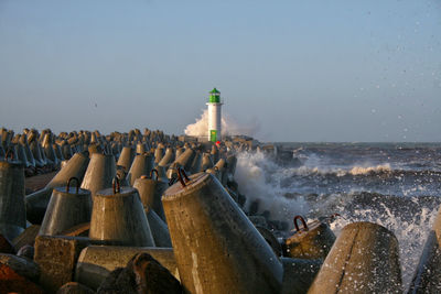 Panoramic view of lighthouse on beach against sky