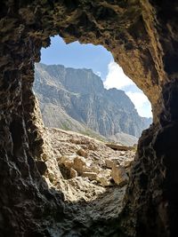 Scenic view of mountains seen through cave