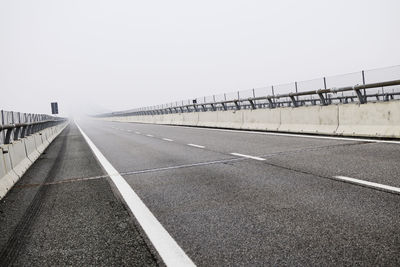 Empty road against clear sky