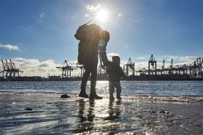 People at beach against sky