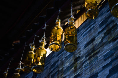 Low angle view of illuminated chandelier hanging from ceiling