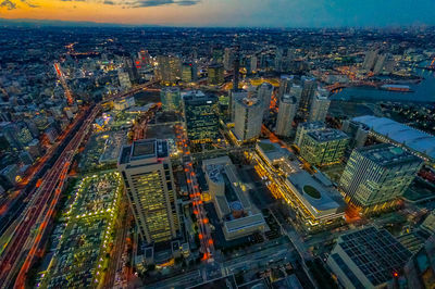 High angle view of illuminated city buildings against sky