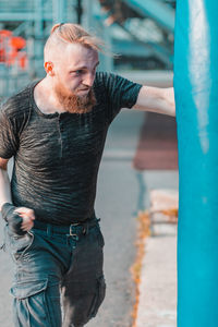 Young man looking at camera in city