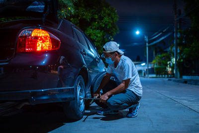 Man working on street at night