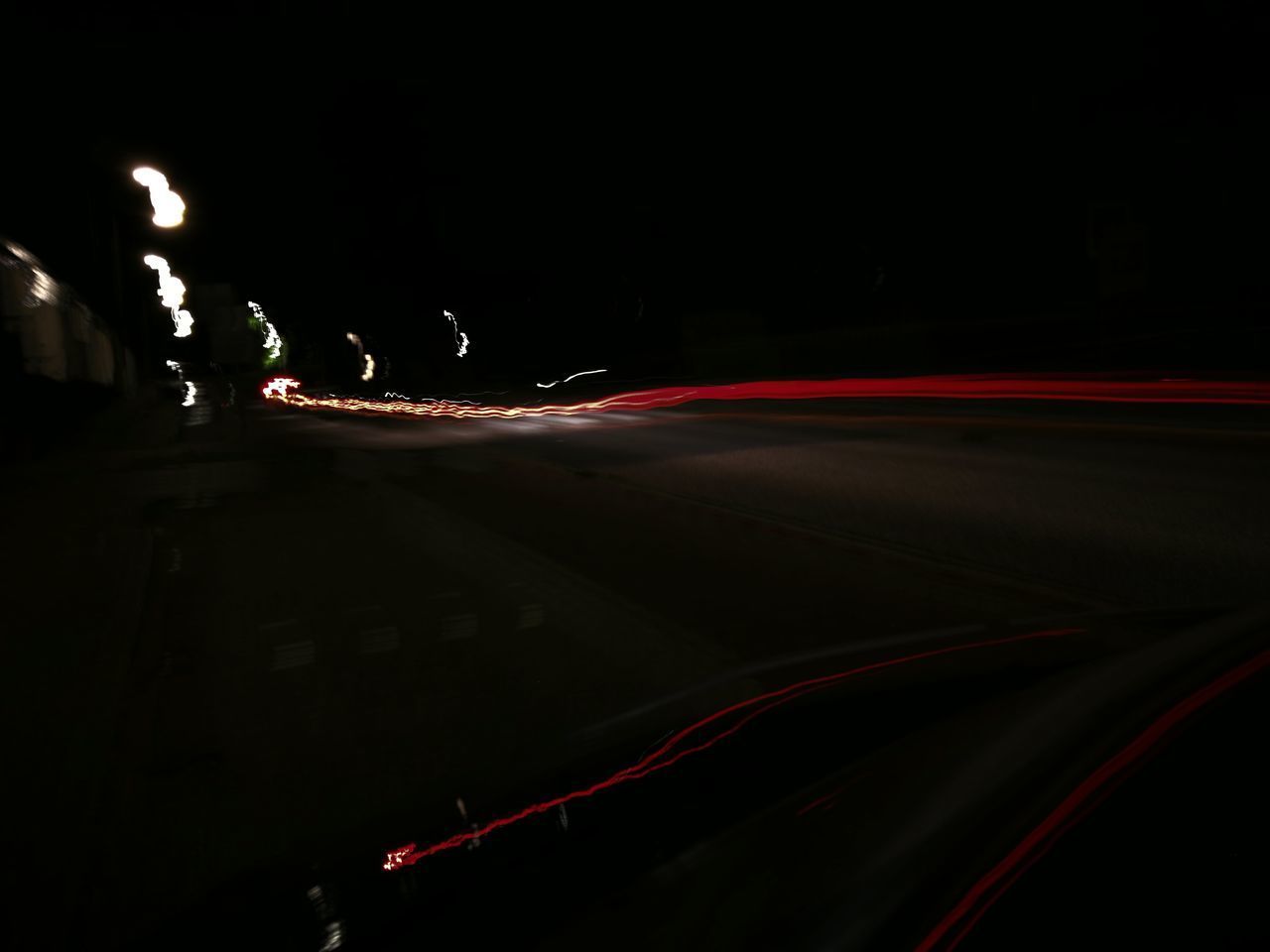 LIGHT TRAILS ON CITY STREET AT NIGHT