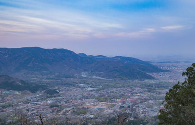 Scenic view of mountains against cloudy sky