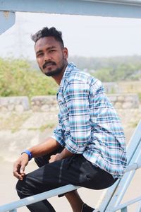 Young man sitting outdoors