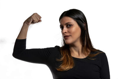 Portrait of young woman against white background