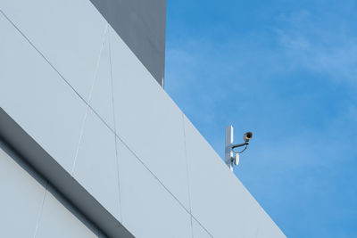 Low angle view of bird on building against sky