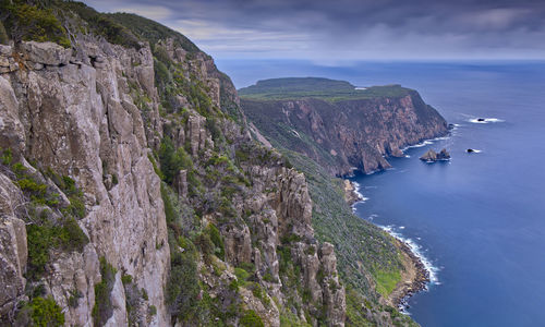 High angle view of rocks by sea against sky