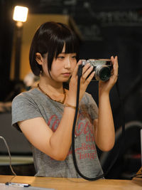 Young woman photographing with camera
