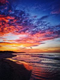 Scenic view of sea against orange sky