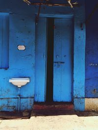 Closed blue door of old building