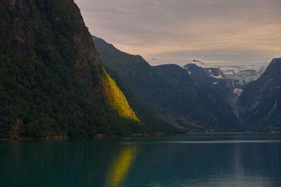 Scenic view of lake and mountains against sky