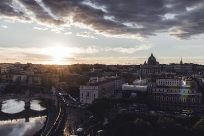 High angle view of city buildings against cloudy sky