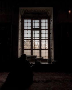 Silhouette of man sitting at home