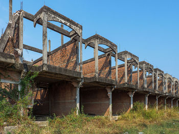 Low angle view of rusty metallic structure against sky