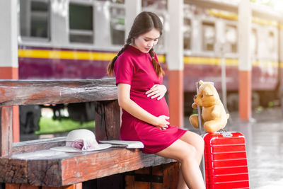 Side view of young woman working at home