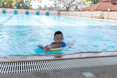 Portrait of boy swimming in pool